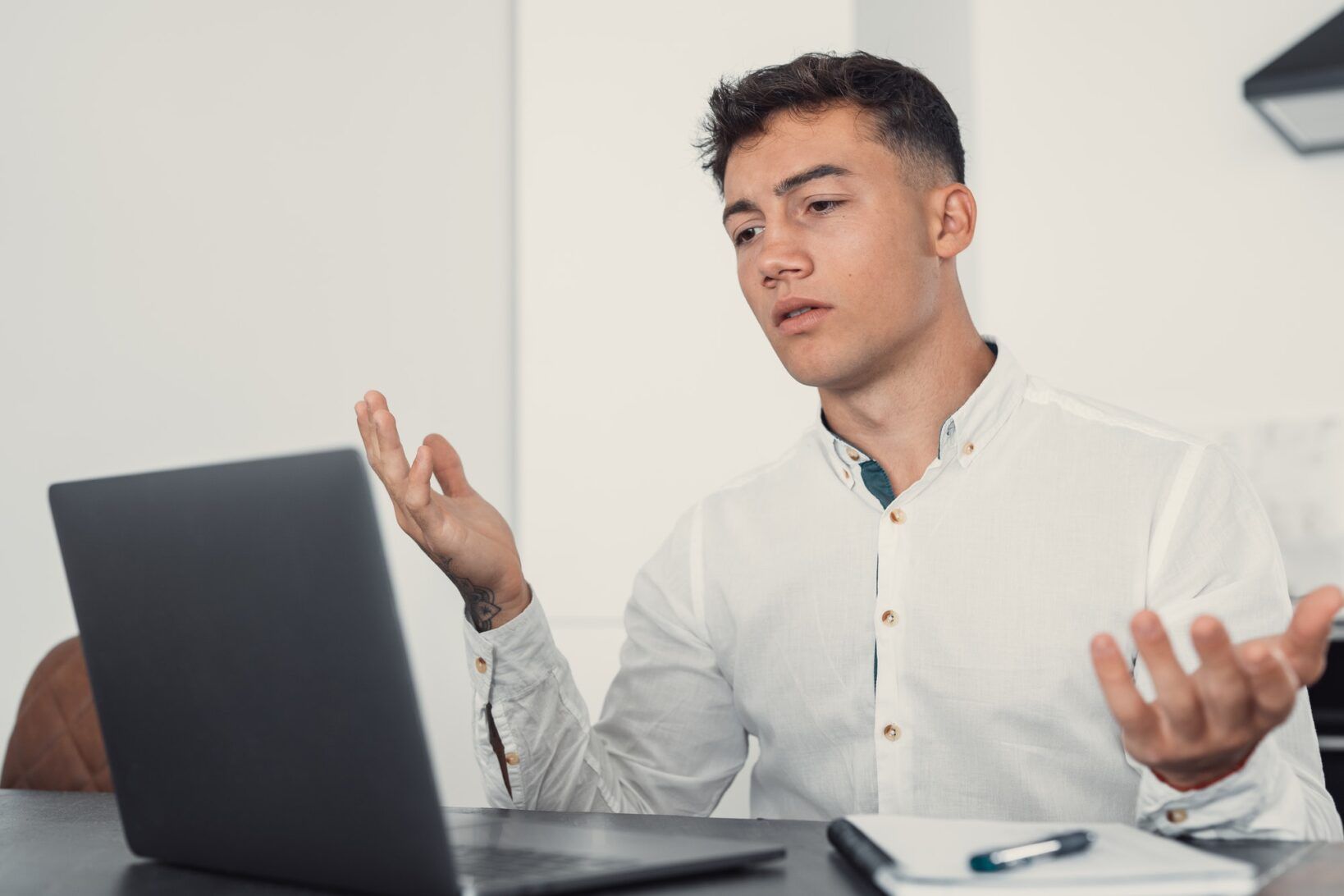 UnhapUnhappy young caucasian male worker in glasses look at laptop screen